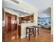 Kitchen with hardwood floors, wooden cabinets, and breakfast bar at 603 Longboat Club Rd # 1102N, Longboat Key, FL 34228