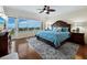 Main bedroom with king-size bed, wood furniture, and water view at 603 Longboat Club Rd # 1102N, Longboat Key, FL 34228