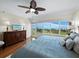 Main bedroom with king-size bed, wood furniture, and water view at 603 Longboat Club Rd # 1102N, Longboat Key, FL 34228