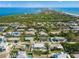 Aerial view showcasing a house with a pool near the coast at 605 Jungle Queen Way, Longboat Key, FL 34228