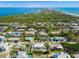 Aerial view of a home with a pool near the water at 605 Jungle Queen Way, Longboat Key, FL 34228