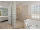 Spa-like bathroom with walk-in shower and soaking tub at 605 Jungle Queen Way, Longboat Key, FL 34228