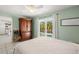 Bedroom with a wooden armoire and pool view at 605 Jungle Queen Way, Longboat Key, FL 34228