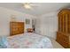 Bedroom with a wooden armoire and access to a full bathroom at 605 Jungle Queen Way, Longboat Key, FL 34228