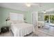 Light and airy bedroom with a large mirror reflecting the backyard at 605 Jungle Queen Way, Longboat Key, FL 34228