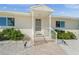 Front entry of the home with a walkway leading to the front door at 605 Jungle Queen Way, Longboat Key, FL 34228