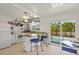 Bright kitchen with white cabinets, granite counters and sliding doors to the pool at 605 Jungle Queen Way, Longboat Key, FL 34228