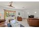 Living room with comfortable leather seating and large windows at 605 Jungle Queen Way, Longboat Key, FL 34228