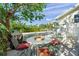 Outdoor patio furniture beneath a shade tree at 605 Jungle Queen Way, Longboat Key, FL 34228