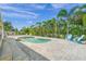 Relaxing pool and patio area with lush landscaping at 605 Jungle Queen Way, Longboat Key, FL 34228