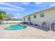 Inviting pool area with patio and lounge chairs at 605 Jungle Queen Way, Longboat Key, FL 34228