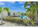 Landscaped pool area with patio and seating at 605 Jungle Queen Way, Longboat Key, FL 34228