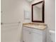 Bathroom with granite countertop, white cabinets and a decorative mirror at 6085 Clubside Dr # 7682, Sarasota, FL 34243