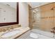 Bathroom with shower/tub combo, granite countertop and tiled walls at 6085 Clubside Dr # 7682, Sarasota, FL 34243