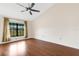 Spacious bedroom with wood floors and large window at 6085 Clubside Dr # 7682, Sarasota, FL 34243