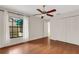 Bright bedroom with wood floors, large closet, and ceiling fan at 6085 Clubside Dr # 7682, Sarasota, FL 34243