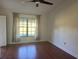 Bright bedroom featuring hardwood floors and a large window at 6085 Clubside Dr # 7682, Sarasota, FL 34243