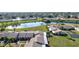 Aerial view showcasing community with lake and lush green spaces at 6131 Heritage Ln # 6131, Bradenton, FL 34209