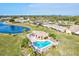 Community pool, spa, and clubhouse with a beautiful lake view at 6131 Heritage Ln # 6131, Bradenton, FL 34209