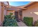 Inviting entryway with covered walkway, lush landscaping, and a charming door at 6131 Heritage Ln # 6131, Bradenton, FL 34209
