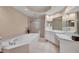 Elegant bathroom with a soaking tub and double vanity at 6310 Watercrest Way # 201, Lakewood Ranch, FL 34202