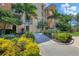 Well-maintained condo building entrance with tropical landscaping at 6310 Watercrest Way # 201, Lakewood Ranch, FL 34202