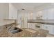 Modern kitchen featuring granite countertops and white cabinetry at 6310 Watercrest Way # 201, Lakewood Ranch, FL 34202