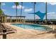 Inviting pool area with lounge chairs, pergola, and shade structure at 6310 Watercrest Way # 201, Lakewood Ranch, FL 34202