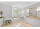 Elegant bathroom featuring a soaking tub and double vanity at 662 Fernwalk Ln, Osprey, FL 34229