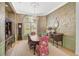 Elegant dining room with wood flooring, a floral wallpaper, and period furniture at 662 Fernwalk Ln, Osprey, FL 34229