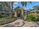 Beautiful home exterior featuring a brick walkway, lush landscaping, and a grand entrance at 662 Fernwalk Ln, Osprey, FL 34229