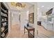 Bright hallway with hardwood floors, built-in shelving, and views into the kitchen at 662 Fernwalk Ln, Osprey, FL 34229