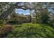 Single-story home with a swing and lush landscaping at 662 Fernwalk Ln, Osprey, FL 34229