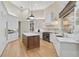 Modern kitchen with white cabinetry, a large island, and top-of-the-line appliances at 662 Fernwalk Ln, Osprey, FL 34229