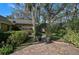 Brick pathway leads to a garden arch at 662 Fernwalk Ln, Osprey, FL 34229