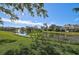 Serene pond view with lush landscaping and fountain at 662 Fernwalk Ln, Osprey, FL 34229