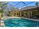 Inviting pool and spa area with screened enclosure and patio furniture at 662 Fernwalk Ln, Osprey, FL 34229