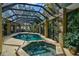 Luxury pool and spa with a covered patio at 662 Fernwalk Ln, Osprey, FL 34229