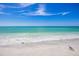 Peaceful beach scene with white sand and gentle waves at 713 Saint Judes S Dr # 2, Longboat Key, FL 34228