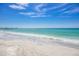 Serene beach view with white sand and clear water at 713 Saint Judes S Dr # 2, Longboat Key, FL 34228