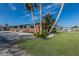 Landscaped yard with brick house and palm trees at 713 Saint Judes S Dr # 2, Longboat Key, FL 34228