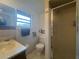 Bathroom with toilet, sink, and stand-up shower at 7564 Joppa St, North Port, FL 34287