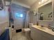 Clean bathroom with tub, shower, and updated vanity at 7564 Joppa St, North Port, FL 34287