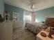 Bright bedroom with floral bedding, ceiling fan, and mirrored dresser at 7564 Joppa St, North Port, FL 34287