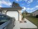 Single car garage with painted flower accents at 7564 Joppa St, North Port, FL 34287