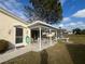 Covered patio with seating area, overlooking the backyard at 7564 Joppa St, North Port, FL 34287