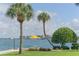 Relaxing waterfront patio with seating, tropical landscaping, and stunning water views at 777 John Ringling Blvd # 2, Sarasota, FL 34236