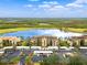 Aerial view of community with lake, golf course, and parking at 7803 Grand Estuary Trl # 102, Bradenton, FL 34212