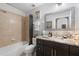 Bathroom with tub, shower, and dark brown vanity at 7803 Grand Estuary Trl # 102, Bradenton, FL 34212