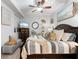 Bright bedroom with large bed, decorative pillows, and ceiling fan at 7803 Grand Estuary Trl # 102, Bradenton, FL 34212